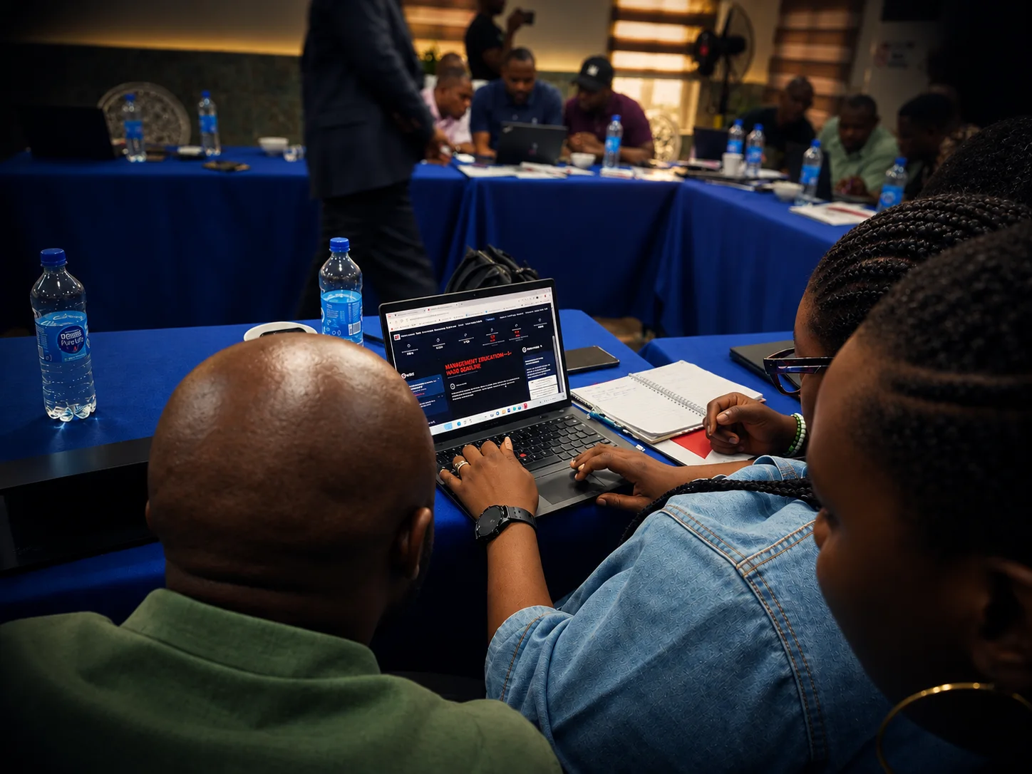 Teams at laptops working through a live War Room simulation session